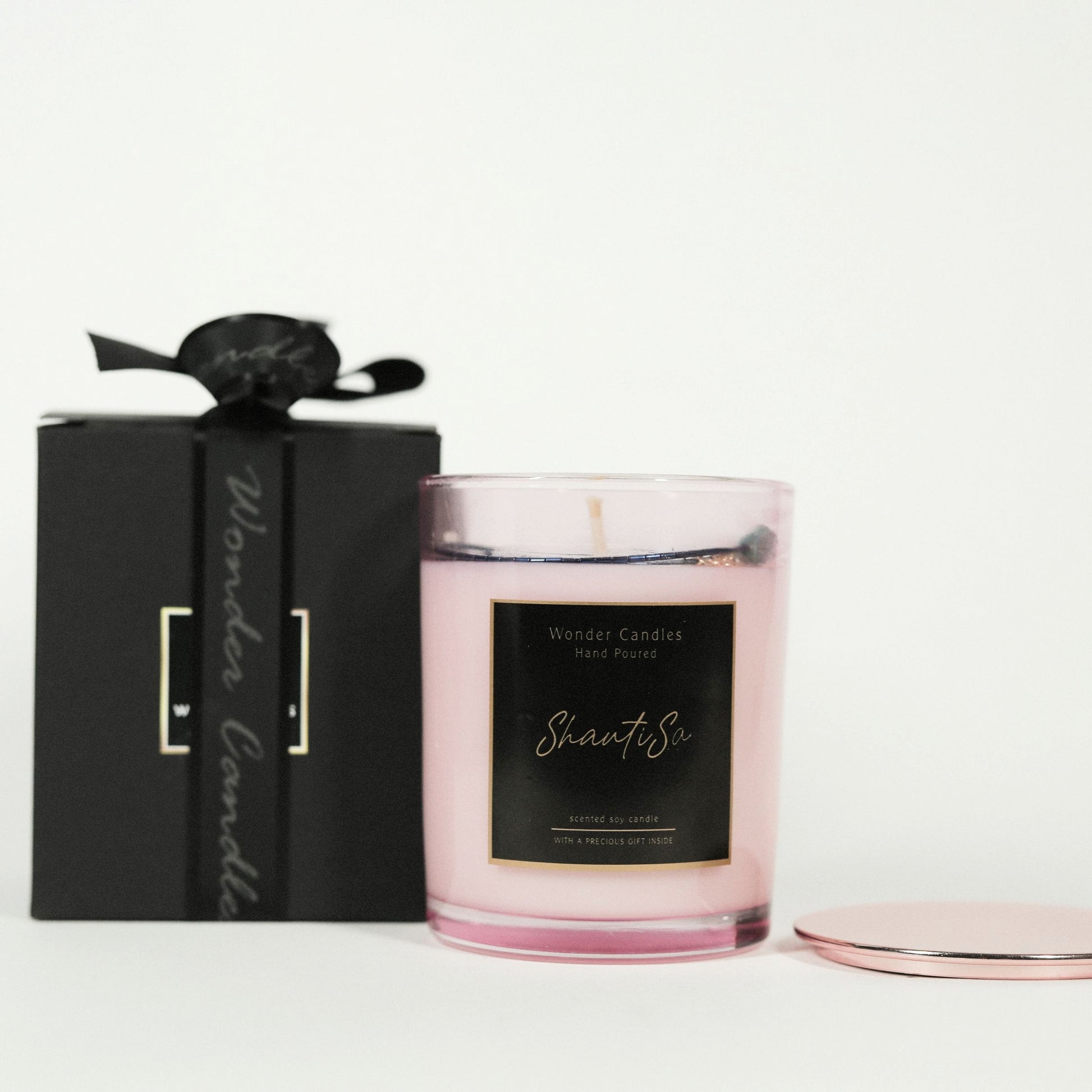 Handcrafted candle with a hidden accessory gift nestled inside, promising a delightful surprise as the wax melts away.